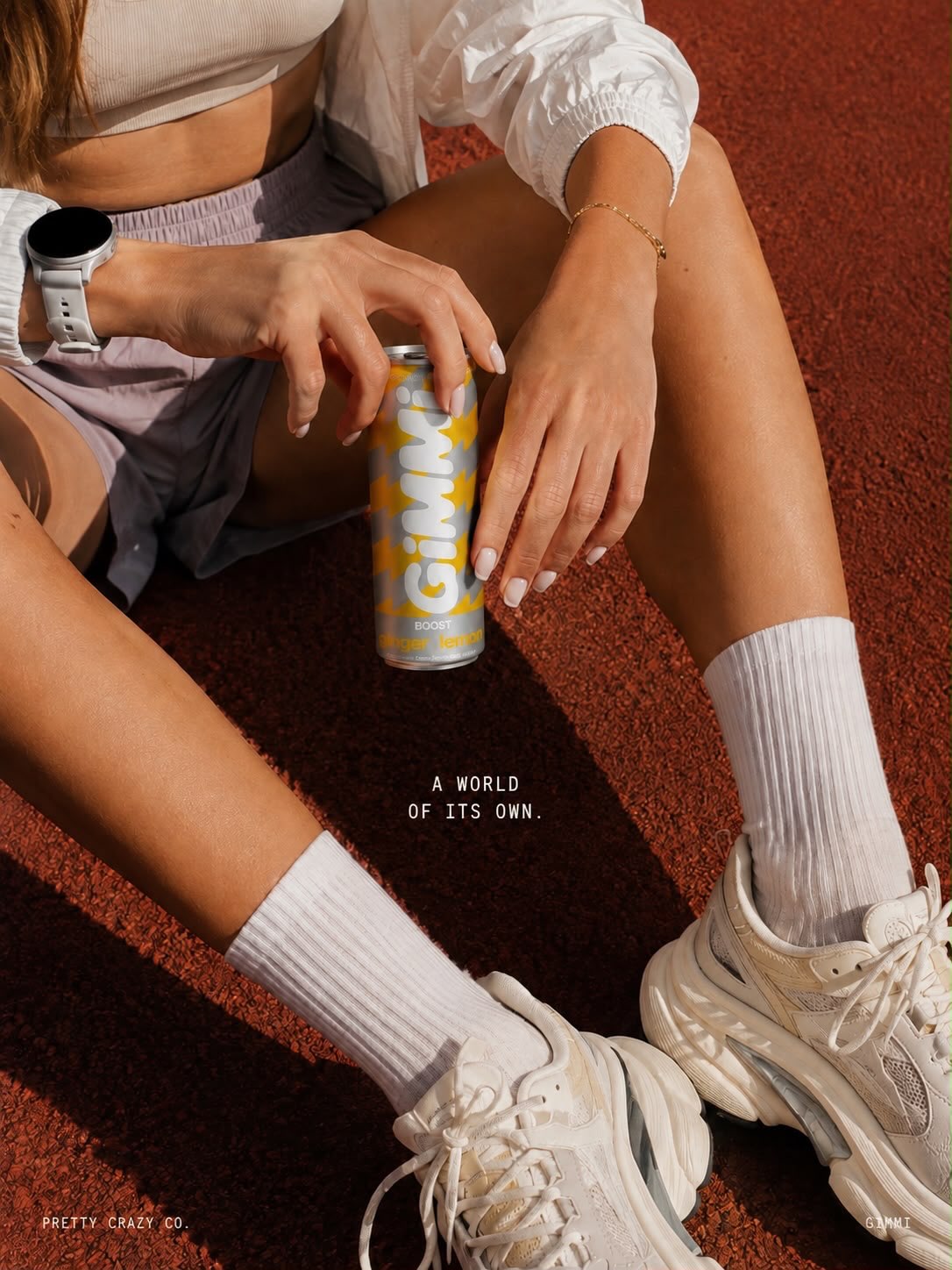 A world of its own: a GIMMI Boost can held by an athlete sitting on a running track